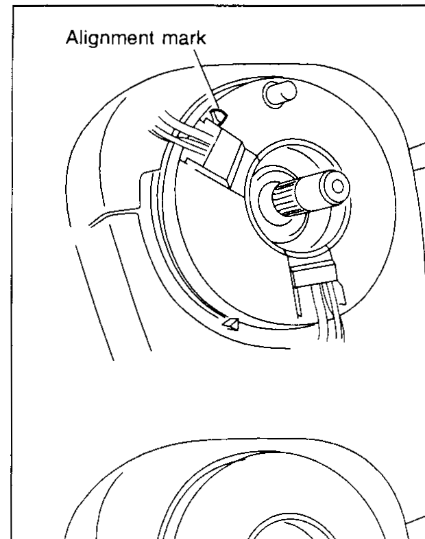 Two-panel illustration of the steering column / spiral cable showing the 'Alignment mark' at the top of the upper panel and at the bottom of the lower panel. The spiral cable hub assembly is shown with the alignment marks indicated by leader lines.