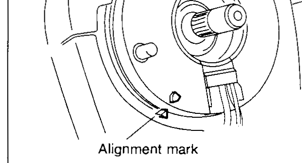 Rear view of the steering wheel showing the spiral cable connector inserted through the wheel hub with curved arrows indicating engaging pawls and routing of the horn connector.
