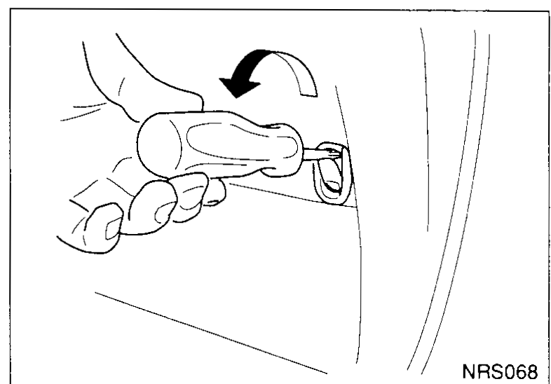 Clip removal tool inserted under the seat back finisher trim to release a trim clip. Arrow shows lift direction.
