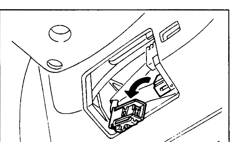 Deployment tool (SST KV99106400) with red and black clips connected to battery terminals, and operator pressing the deployment button.