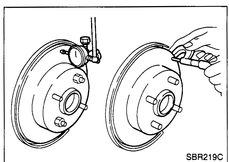 Illustration showing rotor mounted on wheel hub with dial indicator being used to measure runout.