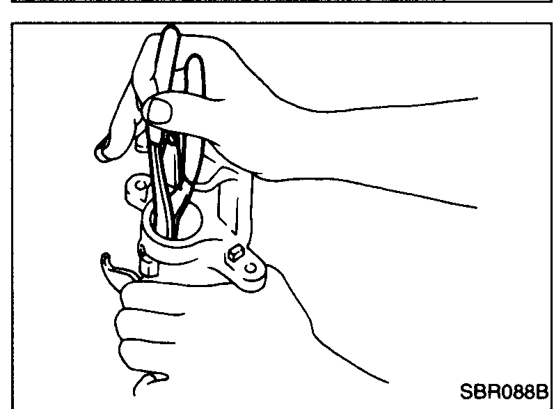 Step 2: pliers prying off Ring A from the piston to expose the adjusting nut.