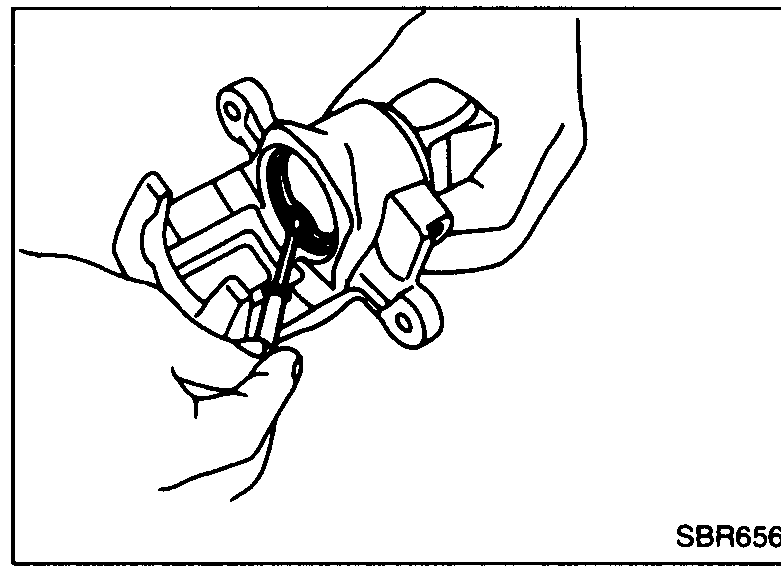 Step 3a: pliers prying off Ring B from cylinder body to release spring cover, spring and seat.