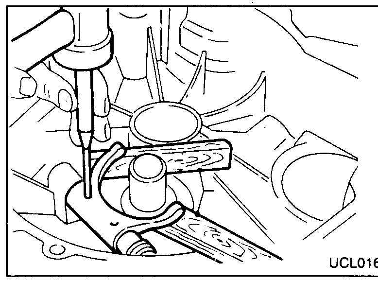 Release-bearing removal: hand pulling the bearing retainers outward to release the bearing from the input-shaft sleeve.