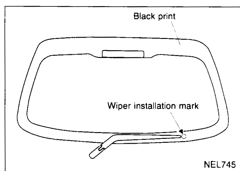 Wiper installation reference: rear hatch glass outline with black print outer trim band; the wiper installation mark is on the upper edge of the black print near the centre. The wiper blade tip parks at the lowest heat wire of the rear-window heater grid.