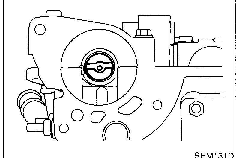Distributor mounting bore on cylinder head with the camshaft drive slot visible. Photograph shows the orientation of the camshaft drive slot at the moment the distributor must be fitted.