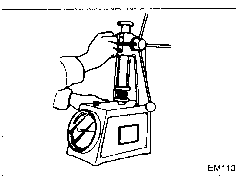 Valve spring stood on a flat surface against a square; gap S between the spring top coil and the square indicates out-of-square dimension.