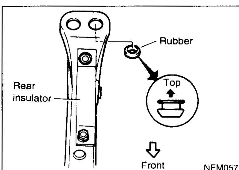Rear engine insulator with rubber bush enlarged in a callout: rubber is shown installed pointing "Top" upward and arrow pointing "Front" indicating its orientation in the vehicle. Labels: Rear insulator, Rubber, Top, Front.