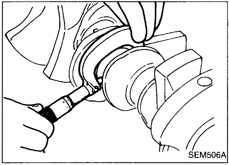 Crankshaft main journal being measured for outer diameter with a micrometer.