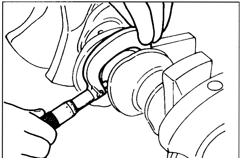 Crankshaft on a stand with a micrometer measuring outer diameter of a crank pin journal.