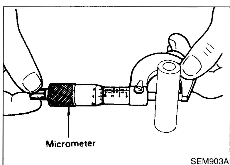 Connecting rod small-end being measured with a small bore gauge to determine bushing inner diameter.