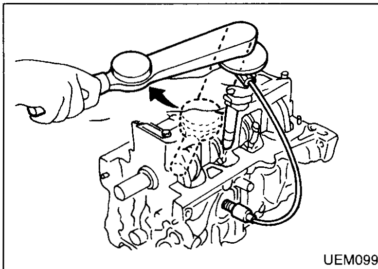Hand pushing a piston/connecting rod assembly into a cylinder bore using a piston ring compressor wrapped around the piston; cylinder block in cross-section. Callout: "Piston ring compressor".
