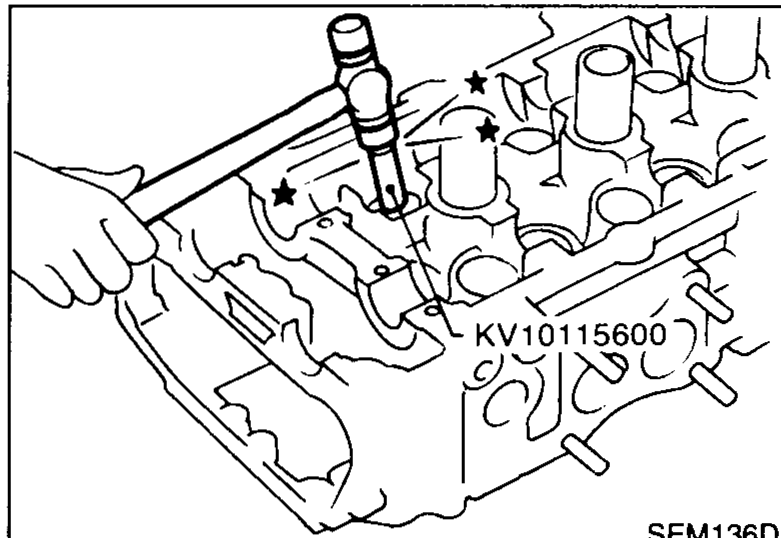 Special tool KV10115600 (oil seal drift) being used by hand to drive a new valve oil seal onto the valve guide of the cylinder head.