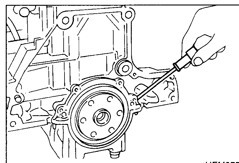 Rear-of-block view showing rear oil seal housing being detached with a screwdriver/pry bar to start removal. Hand pries the housing away from the block.