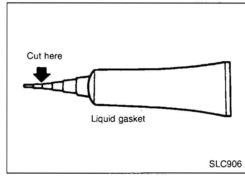Hand scraping old liquid gasket from the oil pan flange with a scraper — illustrating installation step 1.