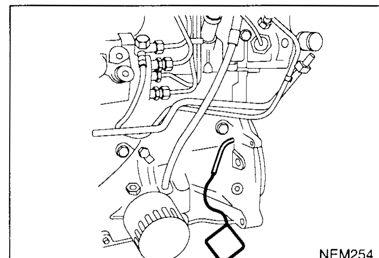 Flywheel access hole with KV109B0112 flywheel locking pin engaged — illustrates tensioning step 1 (re-install flywheel locking pin).