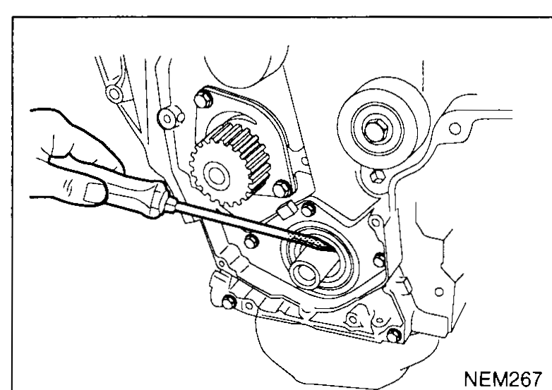 Hand using a screwdriver-style puller to pry the crankshaft front oil seal from the timing-cover housing — illustrates crankshaft-front-oil-seal step 2.