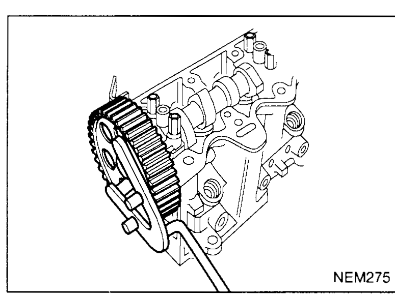Cylinder head on bench with the SST KV109B0070 pulley-holding tool engaged on the camshaft sprocket to keep it from rotating while the sprocket/hub bolt is removed — illustrates disassembly step 2.
