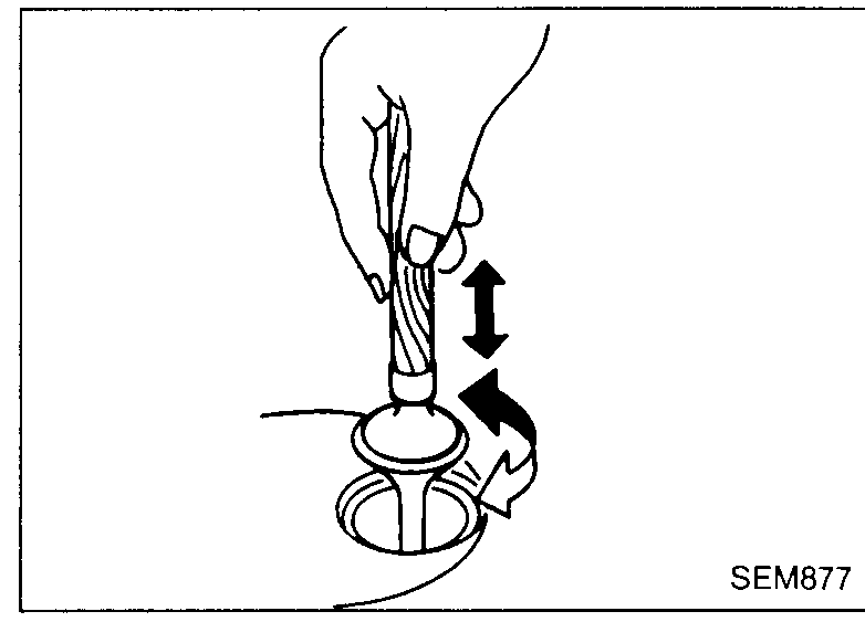 Both hands holding a valve-seat cutter / grinder tool spinning it on the valve seat — illustrates valve-seat-replacement step 5 (cut or grind valve seat).
