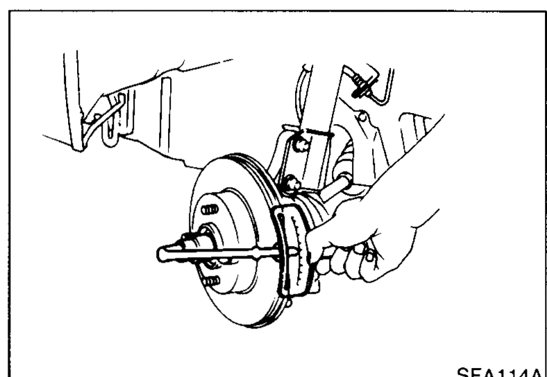 Photo of the wheel-bearing lock nut being tightened on the wheel hub with the hub installed in the knuckle.