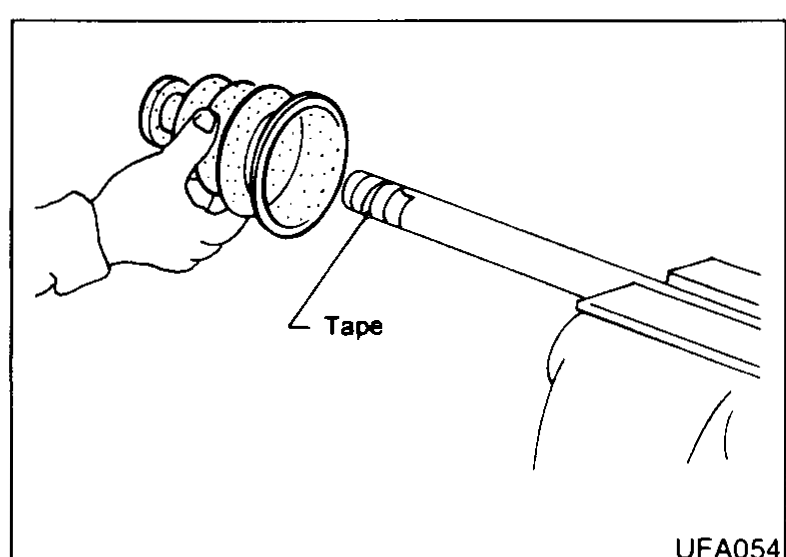 Transaxle-side drive-shaft end with the boot held over the splined end and the splines wrapped in 'Tape' to protect the boot during installation.