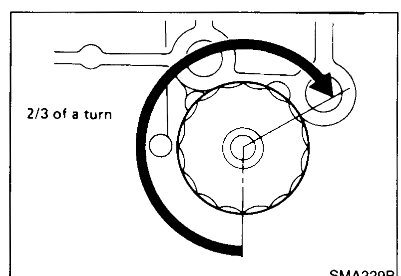 Hand applying engine oil to the rubber seal of a new oil filter before installation.