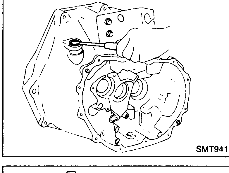 Removing the clutch control shaft oil seal from the clutch housing using a pick/hook tool.