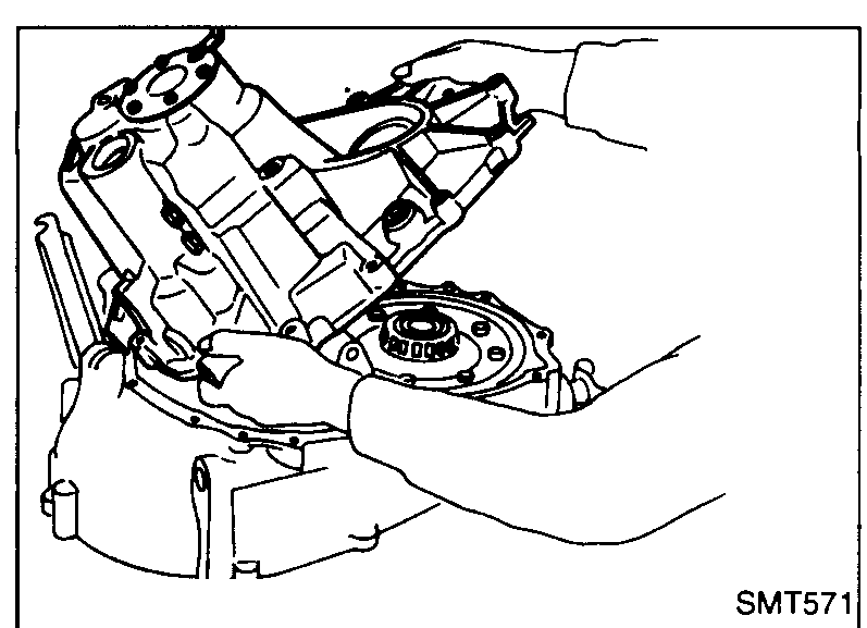Technician's hands tilting the transmission case off the clutch housing, taking care not to interfere with the 5th shift fork during removal.