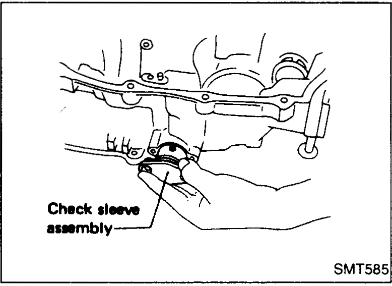 Top of clutch housing with reverse-check bore exposed; callouts identify the reverse check plug, reverse check spring, check ball (Large) and check ball (Small) being detached.
