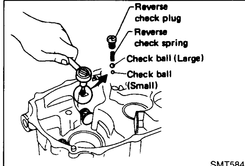 Cutaway/exploded view inside the clutch housing showing reverse check plug, reverse check spring, check ball (Large) and check ball (Small) being installed.