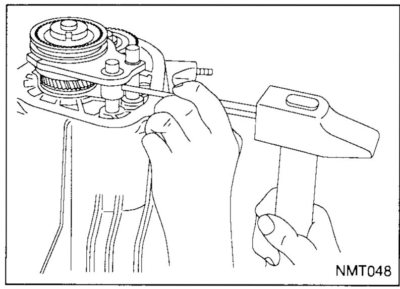Hands using a hammer and pin punch to drift the retaining pin out of the 5th shift fork.