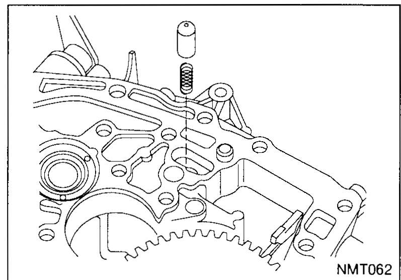 Close-up of the reverse fork locking finger and its spring projecting from the transaxle case bore; the final-drive ring gear is visible below.