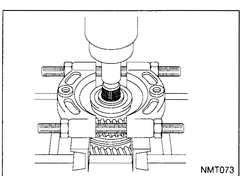 Press setup removing the input shaft rear bearing; the shaft is supported on a fixture and a ram is pressed down on top.