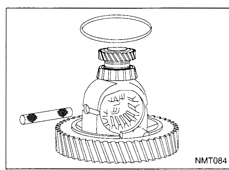 Differential / final-drive case shown vertically, ring gear at the bottom. A pick or punch is being used through the side window of the case to drive out the pinion-mate shaft circlip / pin. A loose circlip-style ring sits on top of the case.