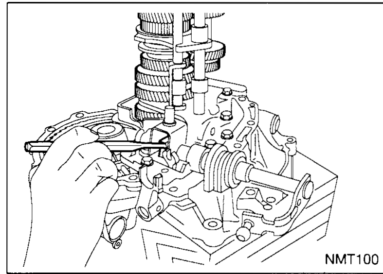 Engagement-shaft area of the case. A short coil spring is held above the bore by a curved arrow indicating its insertion path; the new shaft seal sits on the engagement shaft ready to be pressed into the case bore.