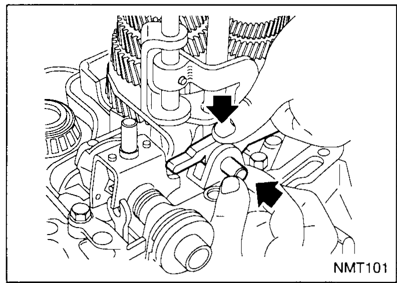 The engagement finger on the shaft being secured by a new roll pin (retaining pin) driven through the cross-bore of the finger and shaft. An arrow points to the roll-pin insertion location.