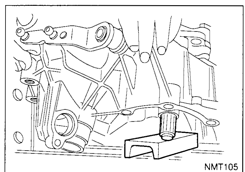 Transaxle casing inverted and positioned on the press table; the input-shaft end protrudes through the bearing bore and rests on a block on the press table.