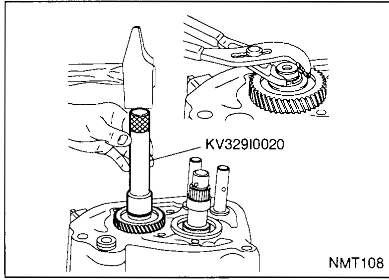 Top of the transaxle case with the new spring washer (loose, top-left) and snap ring (loose, lower) about to be installed on the 5th-input-gear shaft. The shafts protrude from the case.