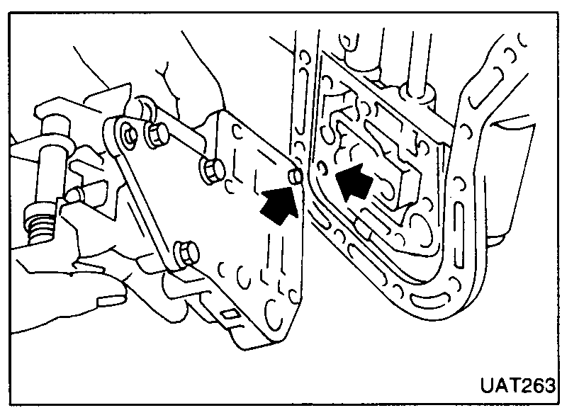 Control valve with holder tool fitted onto transmission; two black arrows indicate engagement points.