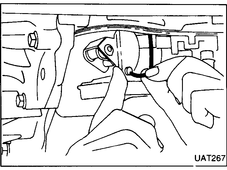 Cable being fitted to the transmission casing, hand visible.