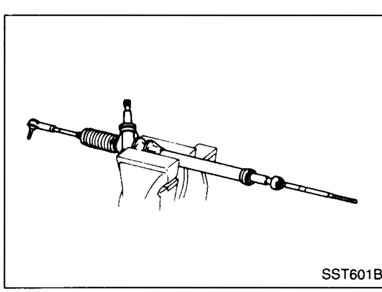 Steering rack held in a bench vise with soft jaws while the outer tie-rod is being separated.